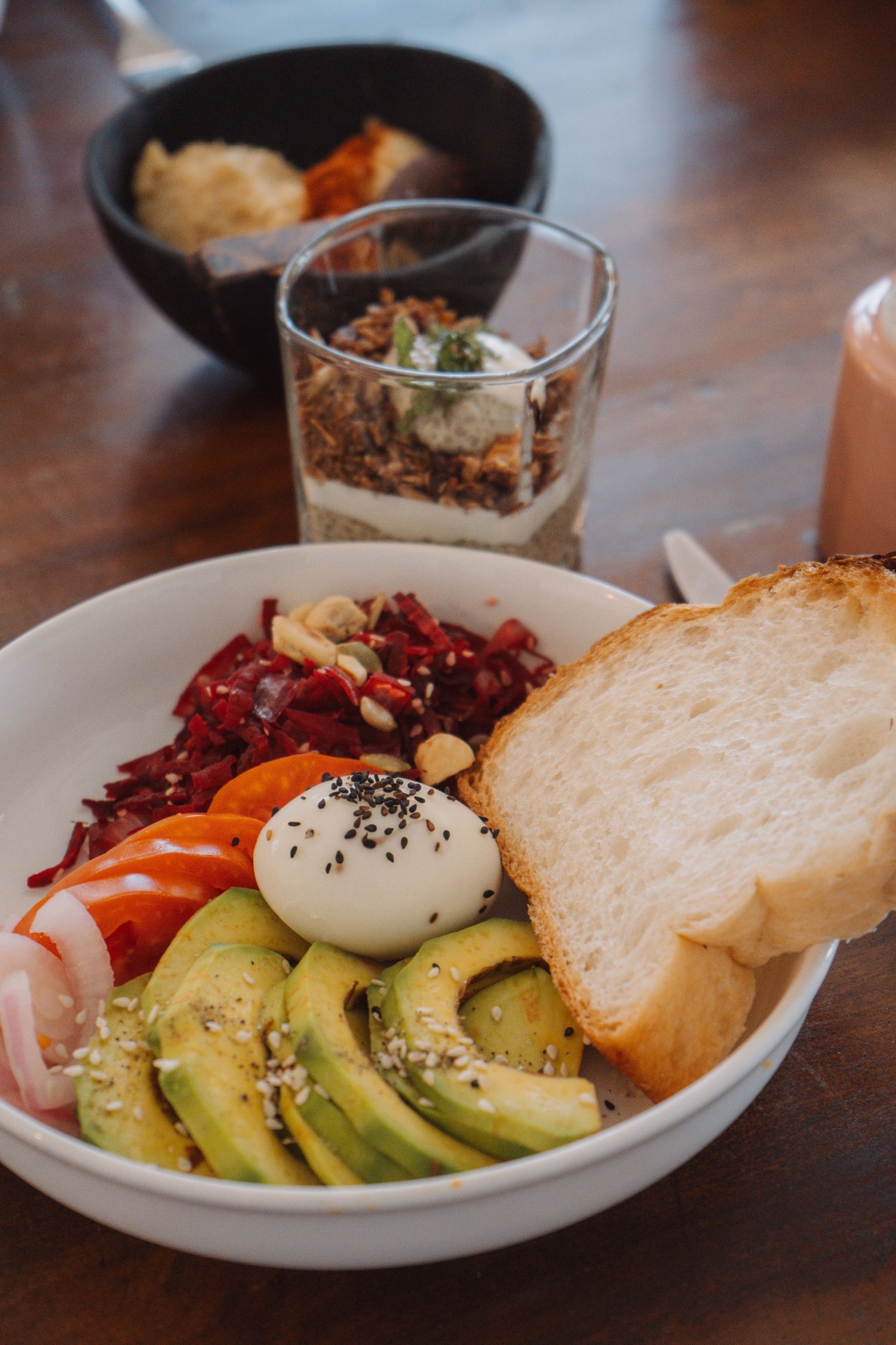 Breakfast bowl with avocado, egg and fresh bread
