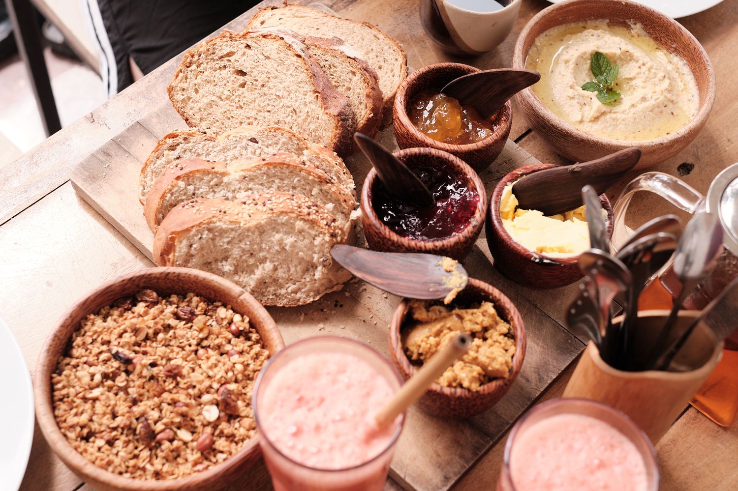 The breakfast board — fresh bread, jams, granola and hummus